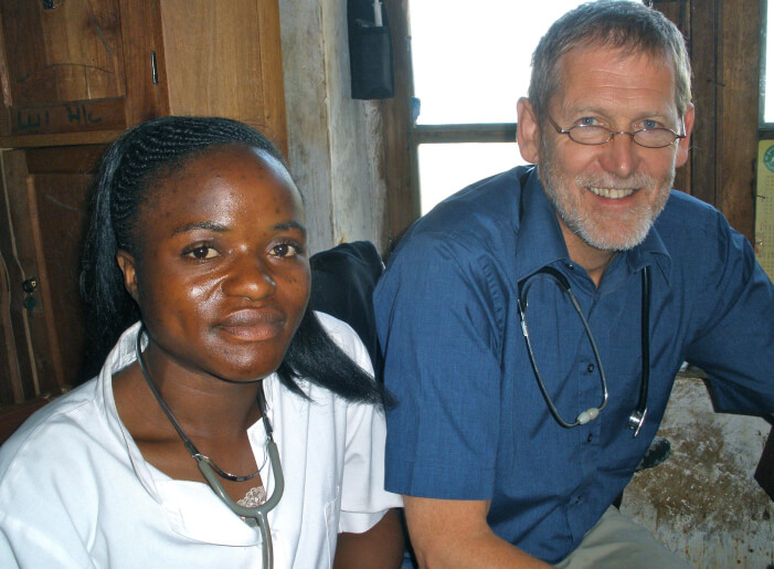 Peter Hearn smiling with an African nurse