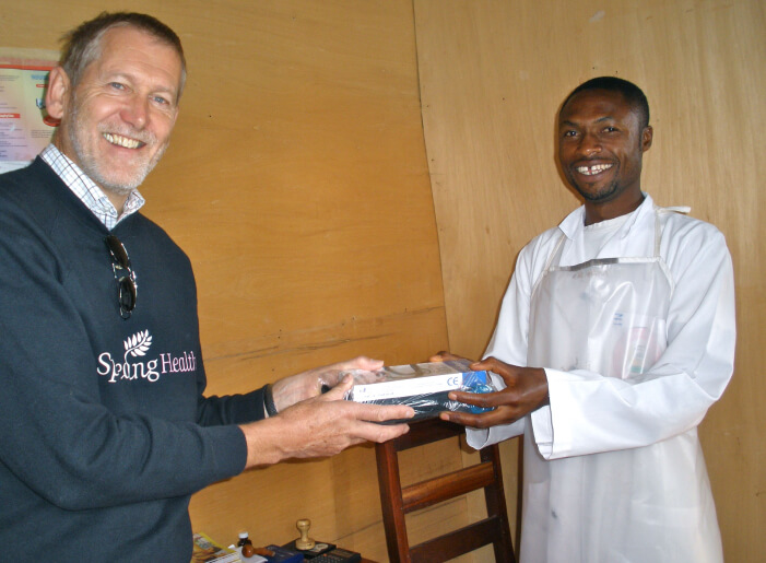 Peter Hearn with a male nurse handing over equipment
